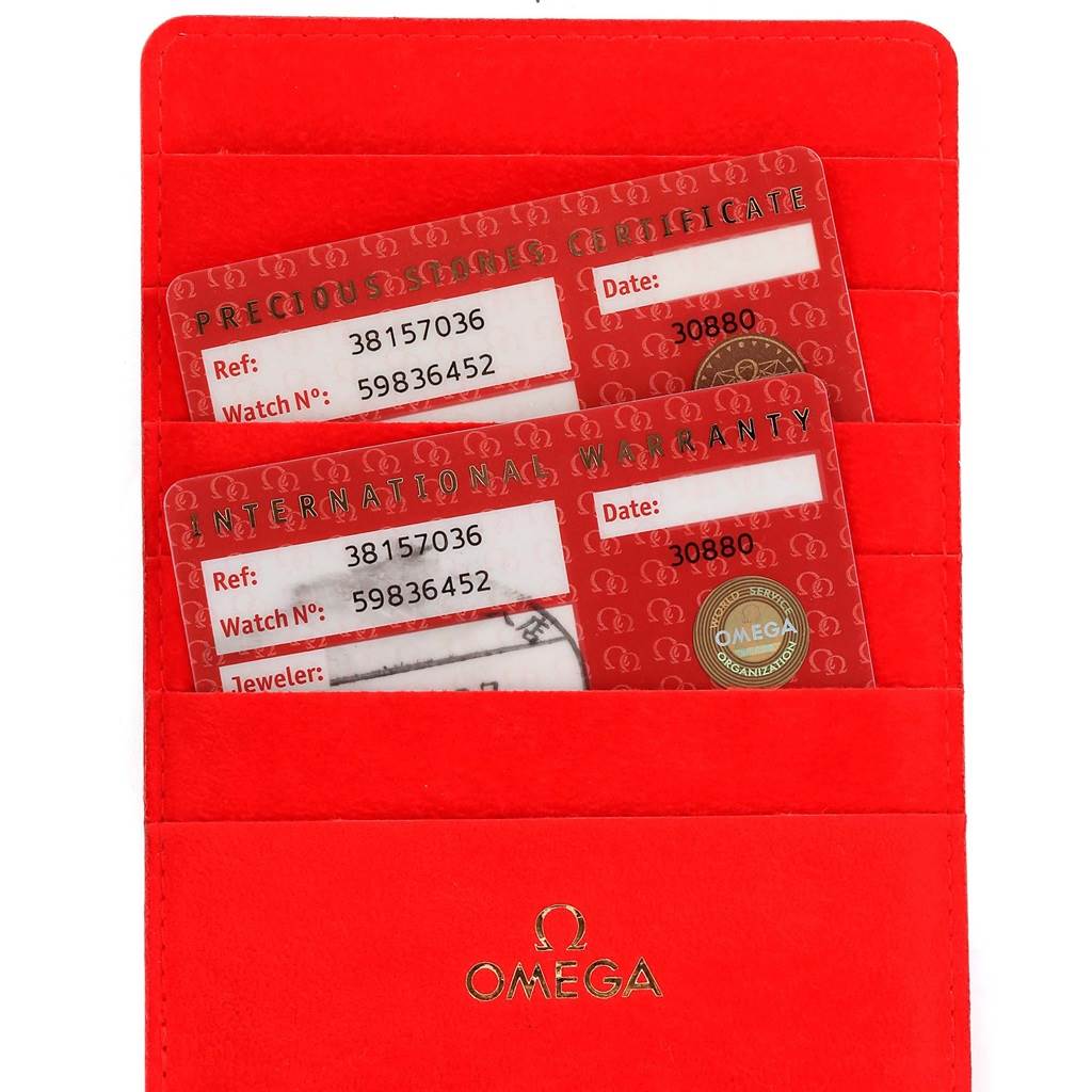 The image shows an Omega 3815.70.36 Women's Stainless Steel Mother of Pearl Dial 3815.70.36 Women's Stainless Steel Mother of Pearl Dial Speedmaster Ladies Diamond MOP Dial Watch 3815.70.36 warranty and certificate cards in a red cardholder.