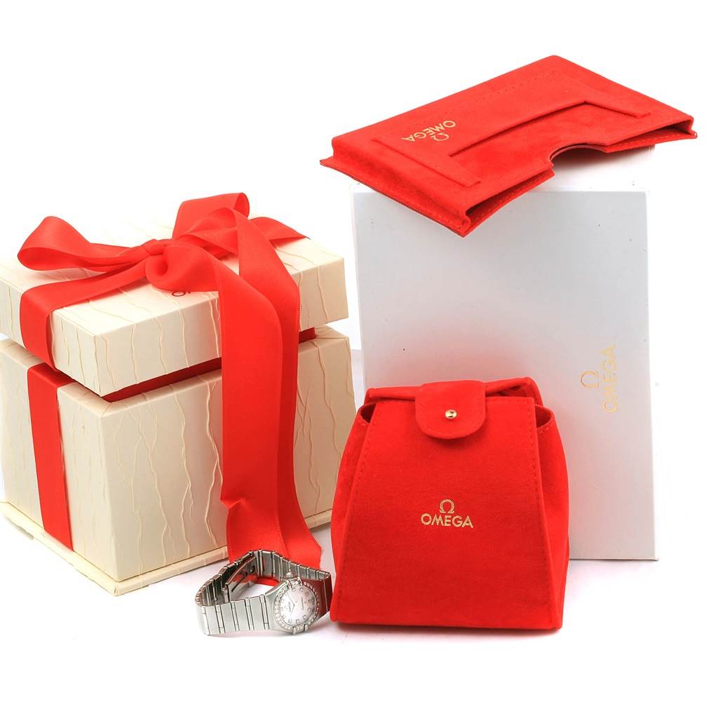 The image shows the Omega 1460.75.00 Women
s Stainless Steel Mother of Pearl Dial 1460.75.00 Women
s Stainless Steel Mother of Pearl Dial Constellation 95 Mini MOP Diamonds Ladies Watch 1460.75.00 with its red pouch, boxes, and packaging.