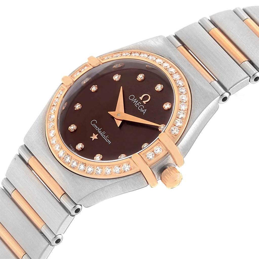 The Omega 1358.60.00 Women's Steel and Gold (two tone) Brown Dial 1358.60.00 Women's Steel and Gold (two tone) Brown Dial Constellation 95 Steel Rose Gold Diamond Watch 1358.60.00 is shown at an angled view, highlighting the face, bezel, and part of the bracelet.