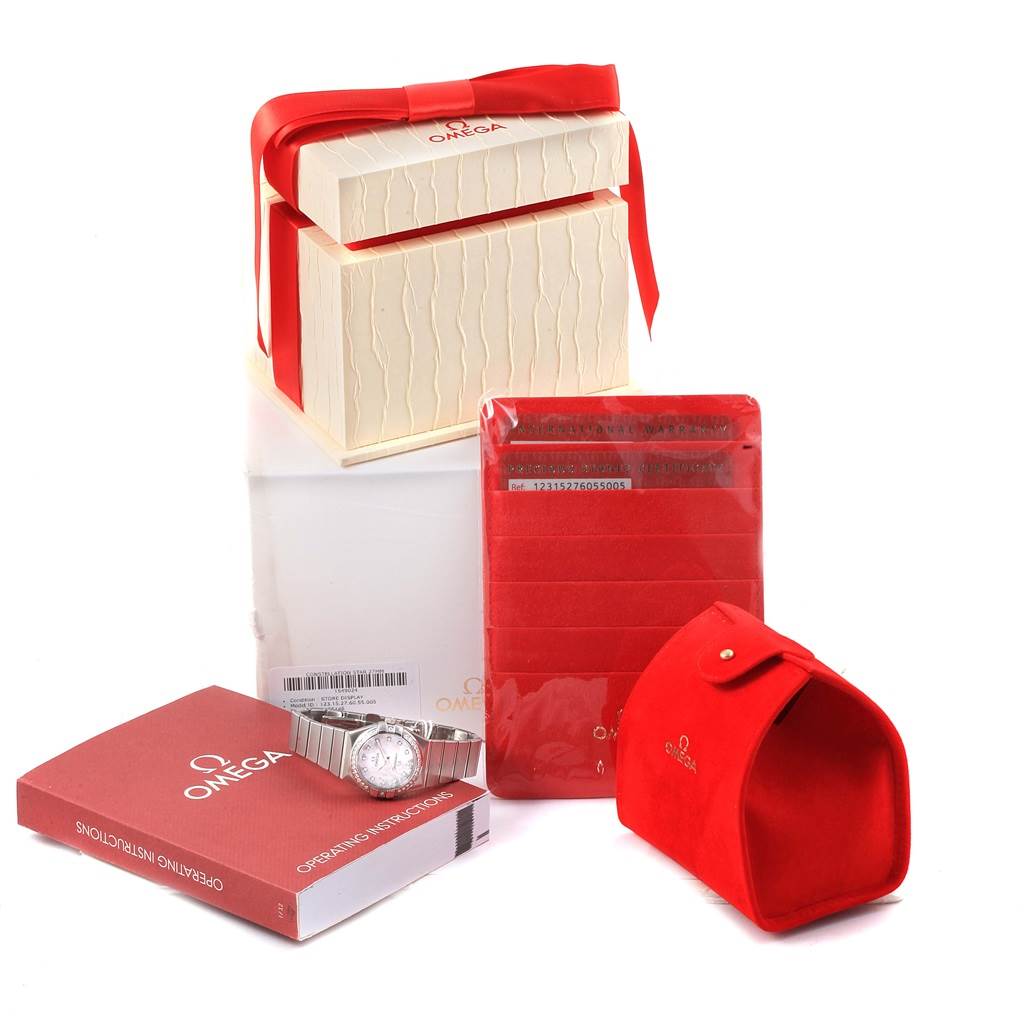 The image shows the Omega 123.15.27.60.55.005 Women
s Stainless Steel Mother of Pearl Dial 123.15.27.60.55.005 Women
s Stainless Steel Mother of Pearl Dial Constellation Diamonds Ladies Watch 123.15.27.60.55.005 and its packaging at an angled view.