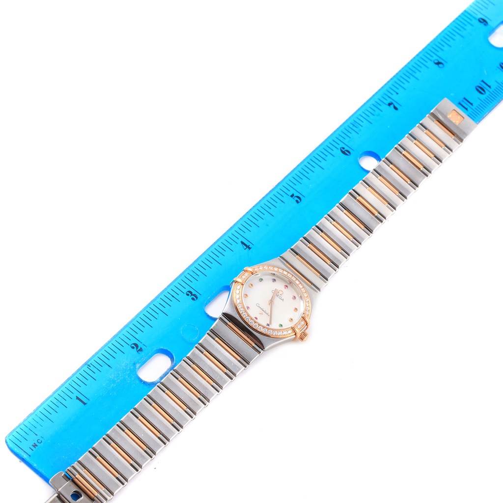 The Omega 1465.79.00 Women
s Steel and Gold (two tone) Mother of Pearl Dial 1465.79.00 Women
s Steel and Gold (two tone) Mother of Pearl Dial Constellation Iris My Choice Steel Rose Gold Ladies Watch 1373.79 is shown from an overhead angle with a ruler for scale.