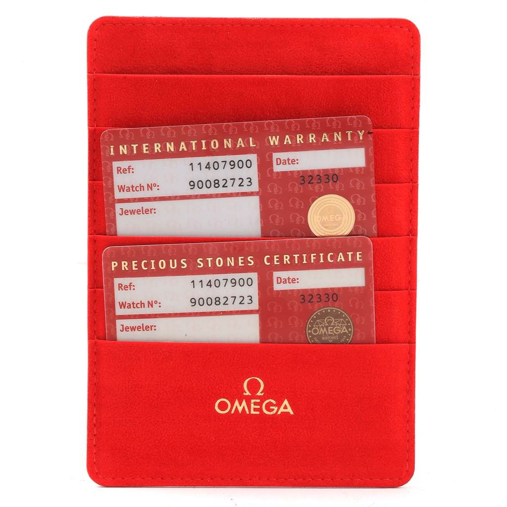 The image shows two cards, the International Warranty and Precious Stones Certificate, in a red Omega 1140.79.00 Women
s Rose Gold Mother of Pearl Dial 1140.79.00 Women
s Rose Gold Mother of Pearl Dial cardholder.