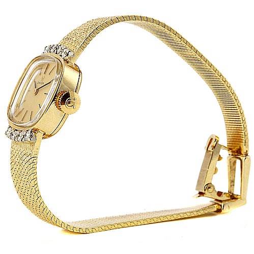 The image shows a side angle of the Omega H7892-R Women's Yellow Gold Champagne Dial H7892-R Women's Yellow Gold Champagne Dial Vintage Ladies 14k Yellow Gold Diamond Watch, highlighting its dial, band, and clasp.