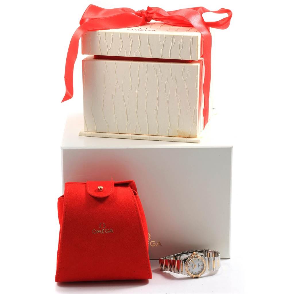 The image shows an Omega 1365.79.00 Women
s Steel and Gold (two tone) Mother of Pearl Dial 1365.79.00 Women
s Steel and Gold (two tone) Mother of Pearl Dial Constellation Iris Steel Yellow Gold Multi Stone Watch 1365.79.00 with packaging, including a red pouch and gift box.