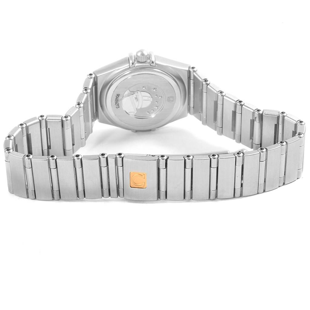 The image shows the back view of an Omega 1460.79.00 Women's Stainless Steel Mother of Pearl Dial 1460.79.00 Women's Stainless Steel Mother of Pearl Dial Constellation Iris Rainbow Multi Stone Watch 1460.79.00 with its metallic bracelet and clasp.