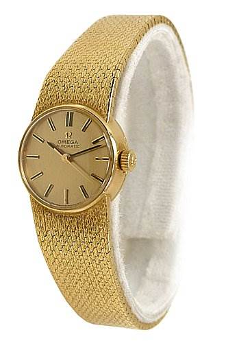 The image shows the front and part of the side view of an Omega 7169 Women's Yellow Gold Champagne Dial 7169 Women's Yellow Gold Champagne Dial Vintage Ladies 18k Yellow Gold 7169 Watch, highlighting its textured band and round face.