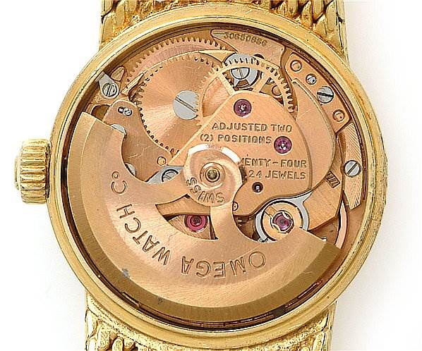 The image shows the back view of the Vintage Ladies 18k Yellow Gold 7169 Watch model by Omega 7169 Women's Yellow Gold Champagne Dial 7169 Women's Yellow Gold Champagne Dial, exposing its internal mechanical parts.