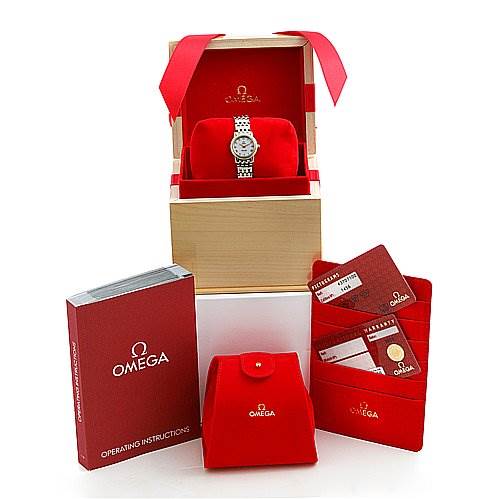 The image shows an Omega 43707100 Women
s Yellow Gold Mother of Pearl Dial 43707100 Women
s Yellow Gold Mother of Pearl Dial De Ville Prestige New Ladies Small Watch, model 43707100, displayed in its box with user manuals and certification cards.