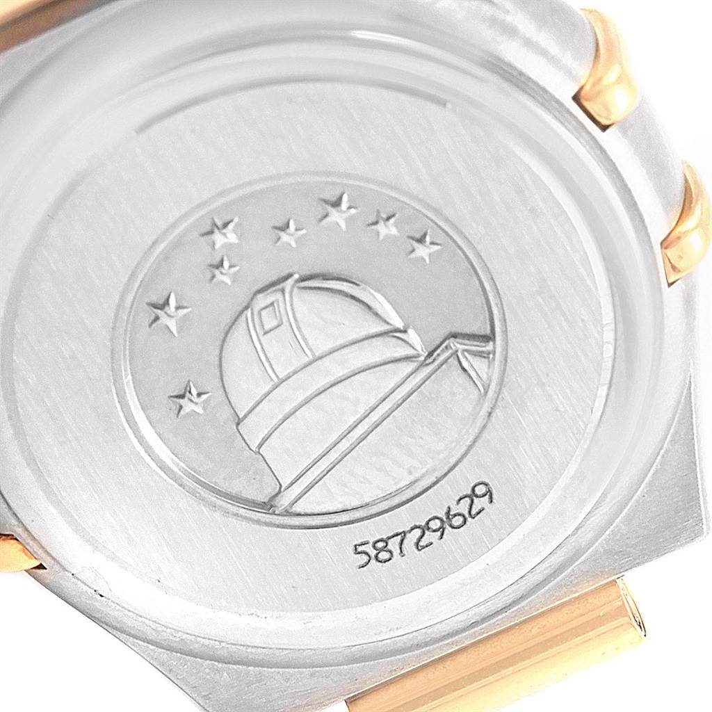 The image shows the back of the Omega 1267.75.00 Women
s Steel and Gold (two tone) Mother of Pearl Dial 1267.75.00 Women
s Steel and Gold (two tone) Mother of Pearl Dial Constellation Mini Mother of Pearl Diamond Watch 1267.75.00 with an observatory embossment.