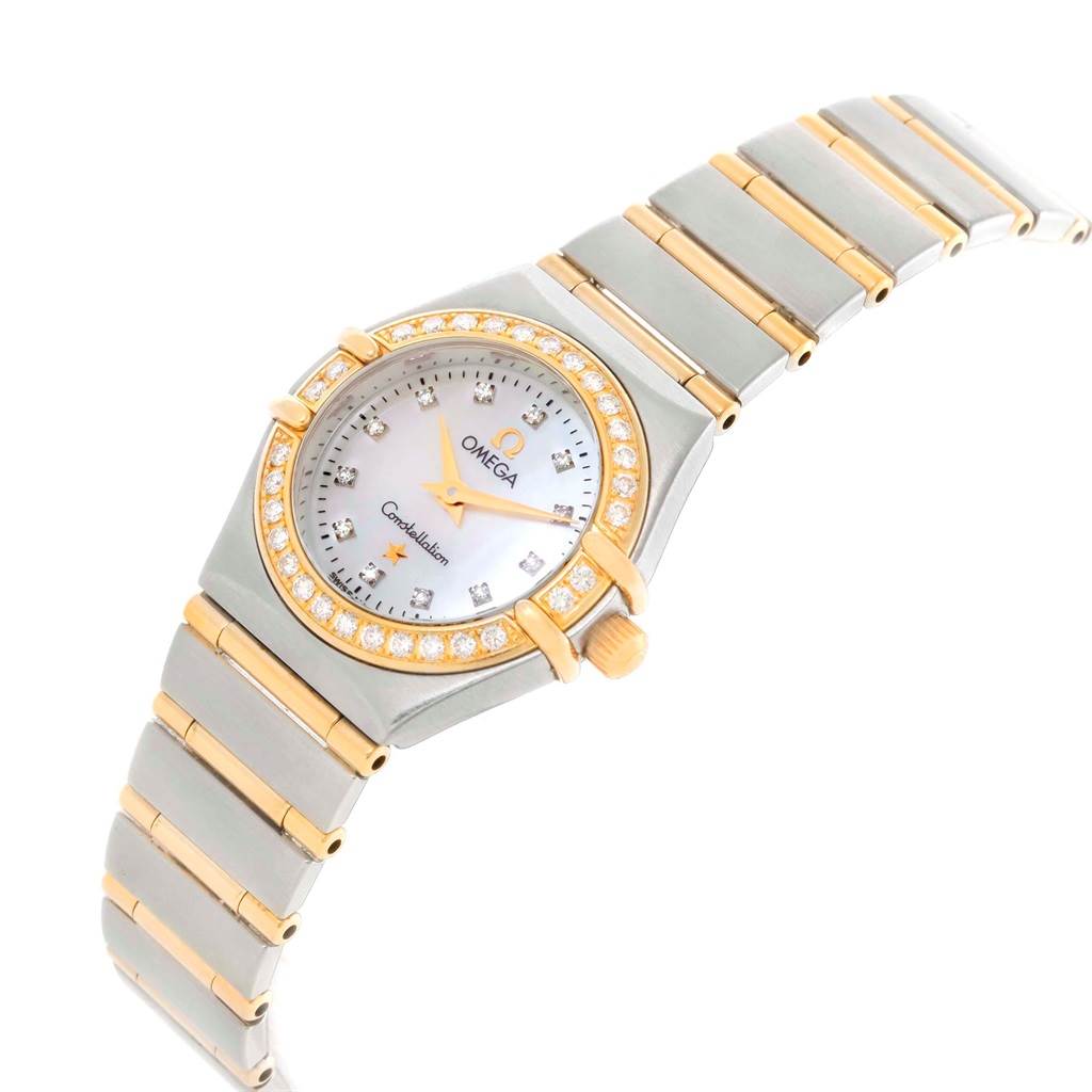 The Omega 1267.75.00 Women
s Steel and Gold (two tone) Mother of Pearl Dial 1267.75.00 Women
s Steel and Gold (two tone) Mother of Pearl Dial Constellation Mini 1267.75.00 watch is shown at a three-quarter angle, highlighting its mother-of-pearl dial and diamond bezel.