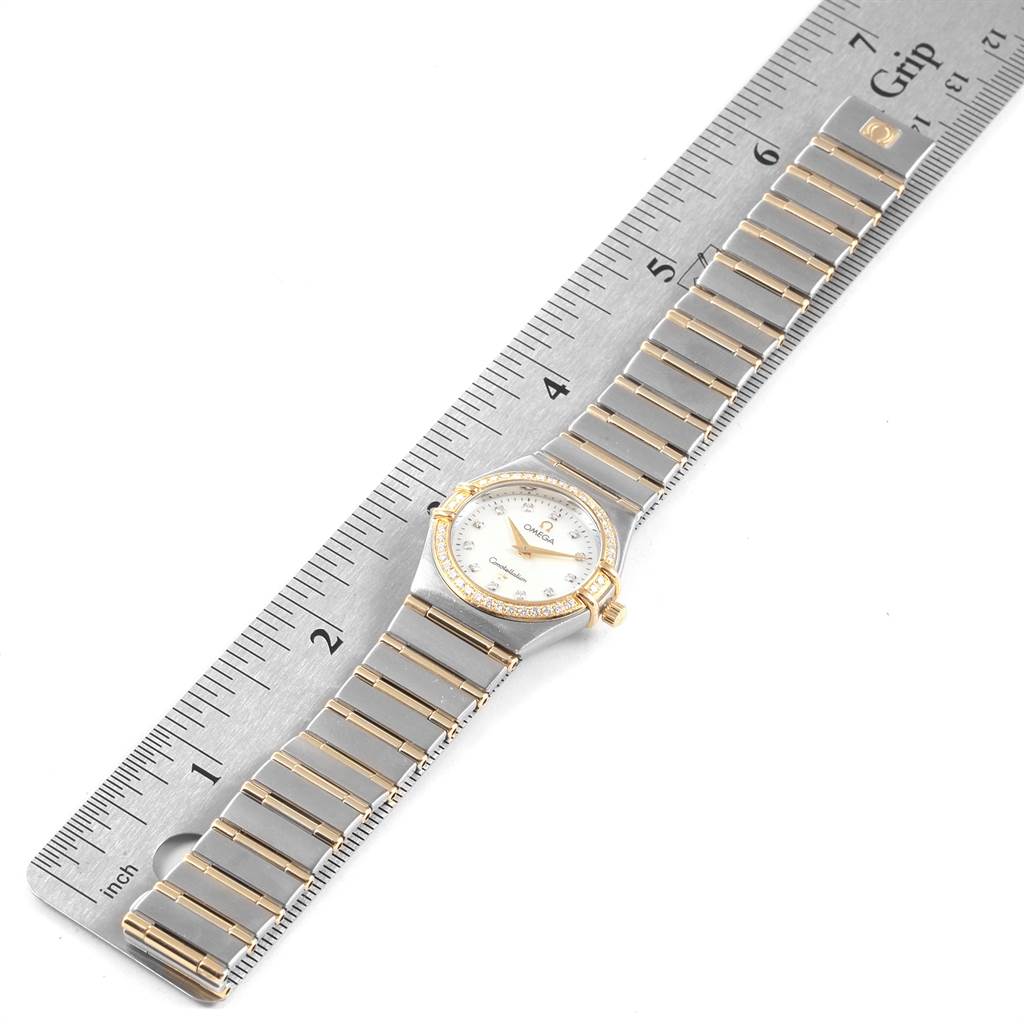 The image shows a top-down view of the Omega 1277.75.00 Women's Steel and Gold (two tone) Mother of Pearl Dial 1277.75.00 Women's Steel and Gold (two tone) Mother of Pearl Dial Constellation 95 Steel Yellow Gold MOP Diamond Watch 1277.75.00, alongside a measurement ruler.
