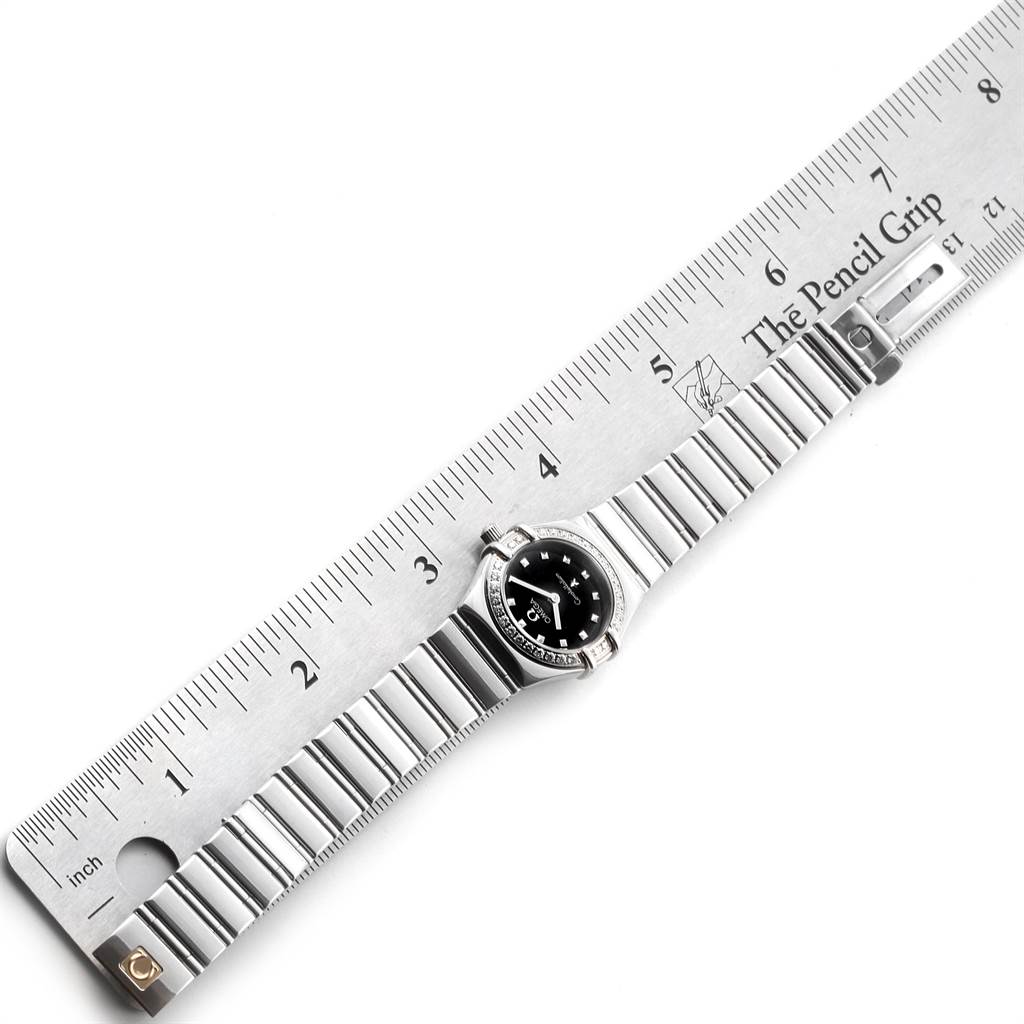 The Omega 1465.51.00 Women's Stainless Steel Black Dial 1465.51.00 Women's Stainless Steel Black Dial Constellation My Choice Mini Ladies Diamond Watch 1465.51.00 is shown with its face and band next to a ruler.