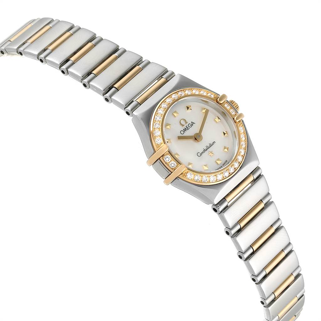 The Omega 1365.71.00 Women's Steel and Gold (two tone) Mother of Pearl Dial 1365.71.00 Women's Steel and Gold (two tone) Mother of Pearl Dial Ladies Constellation Steel Yellow Gold Diamond Mini 1365.71.00 watch is shown at an angle revealing the face, bezel, and bracelet.