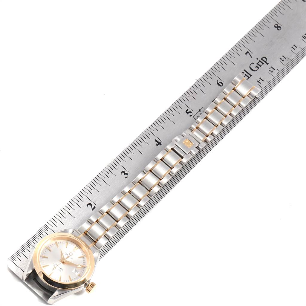 This image shows the Omega 2377.30.00 Women's Steel and Gold (two tone) Silver Dial 2377.30.00 Women's Steel and Gold (two tone) Silver Dial Seamaster Aqua Terra Steel Yellow Gold Ladies Watch 2377.30.00 lying flat with a ruler alongside it.