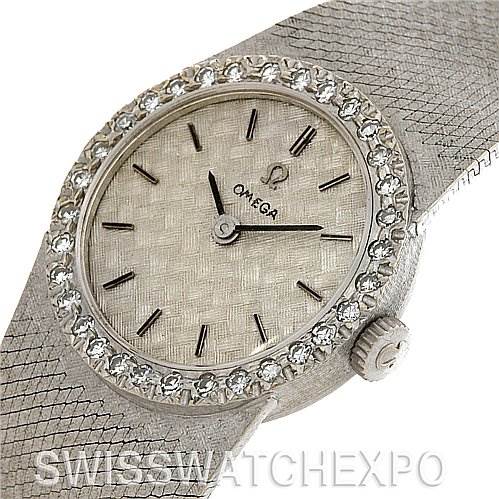 This image shows a close-up, angled view of the face and crown of an Omega 7816 Women's White Gold Silver Dial 7816 Women's White Gold Silver Dial Vintage Ladies 14k White Gold Diamond Watch.