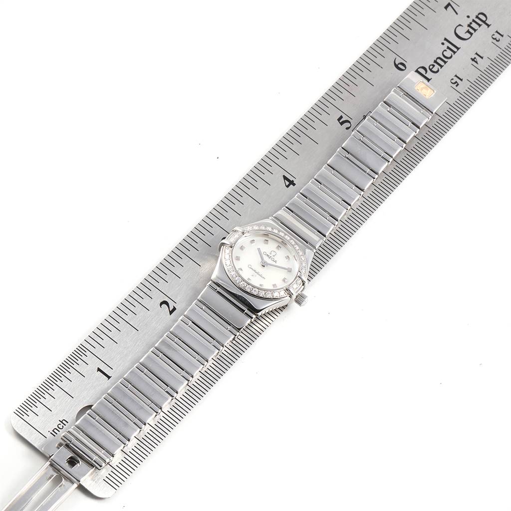 The image shows an overhead view of the Omega 1465.71.00 Women's Stainless Steel Mother of Pearl Dial 1465.71.00 Women's Stainless Steel Mother of Pearl Dial Constellation My Choice Mini Diamond Steel Watch 1465.71.00 laid across a ruler.