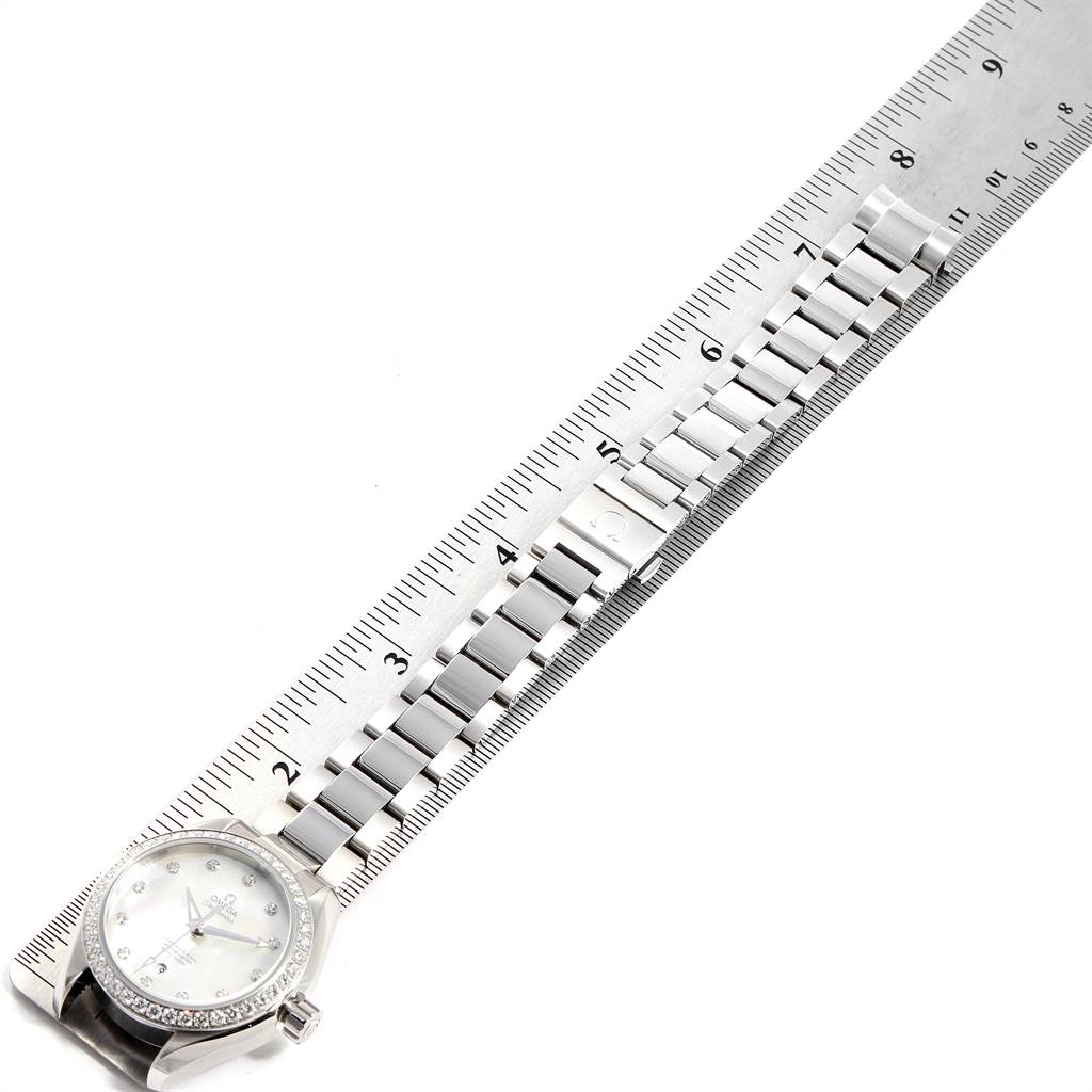 The image shows an Omega 231.15.34.20.55.002 Women's Stainless Steel Mother of Pearl Dial 231.15.34.20.55.002 Women's Stainless Steel Mother of Pearl Dial Aqua Terra 34 Steel Diamond Ladies Watch 231.15.34.20.55.002 placed alongside a ruler, displaying the bracelet length.