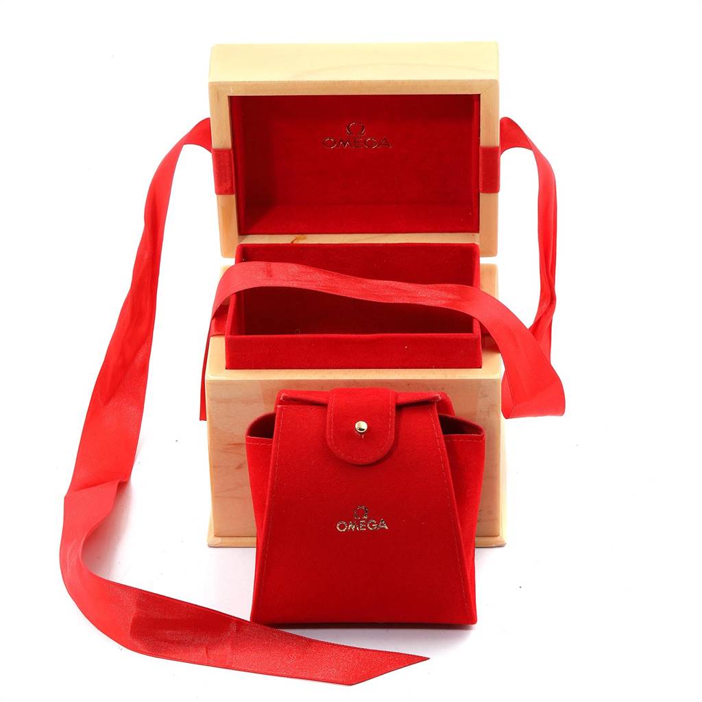The image shows the packaging accessories for the Omega 123.15.24.60.57.001 Women's Stainless Steel Mother of Pearl Dial 123.15.24.60.57.001 Women's Stainless Steel Mother of Pearl Dial Constellation Quartz 24 MOP Diamond Watch, including a red velvet pouch and a wooden box.