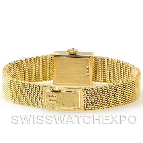 The image shows the back view of the Vintage Ladies 14k Yellow Gold Watch Made For Tiffany by Omega Women's Yellow Gold Silver Dial Women's Yellow Gold Silver Dial, highlighting the clasp and case back.