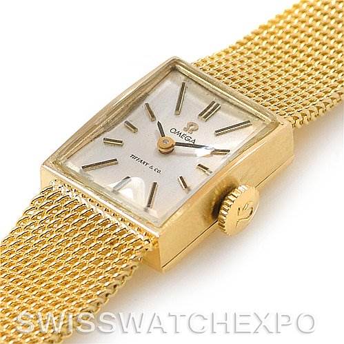 The image shows a side-angle view of the Omega Women's Yellow Gold Silver Dial Women's Yellow Gold Silver Dial Vintage Ladies 14k Yellow Gold Watch Made For Tiffany, highlighting its rectangular face and mesh band.