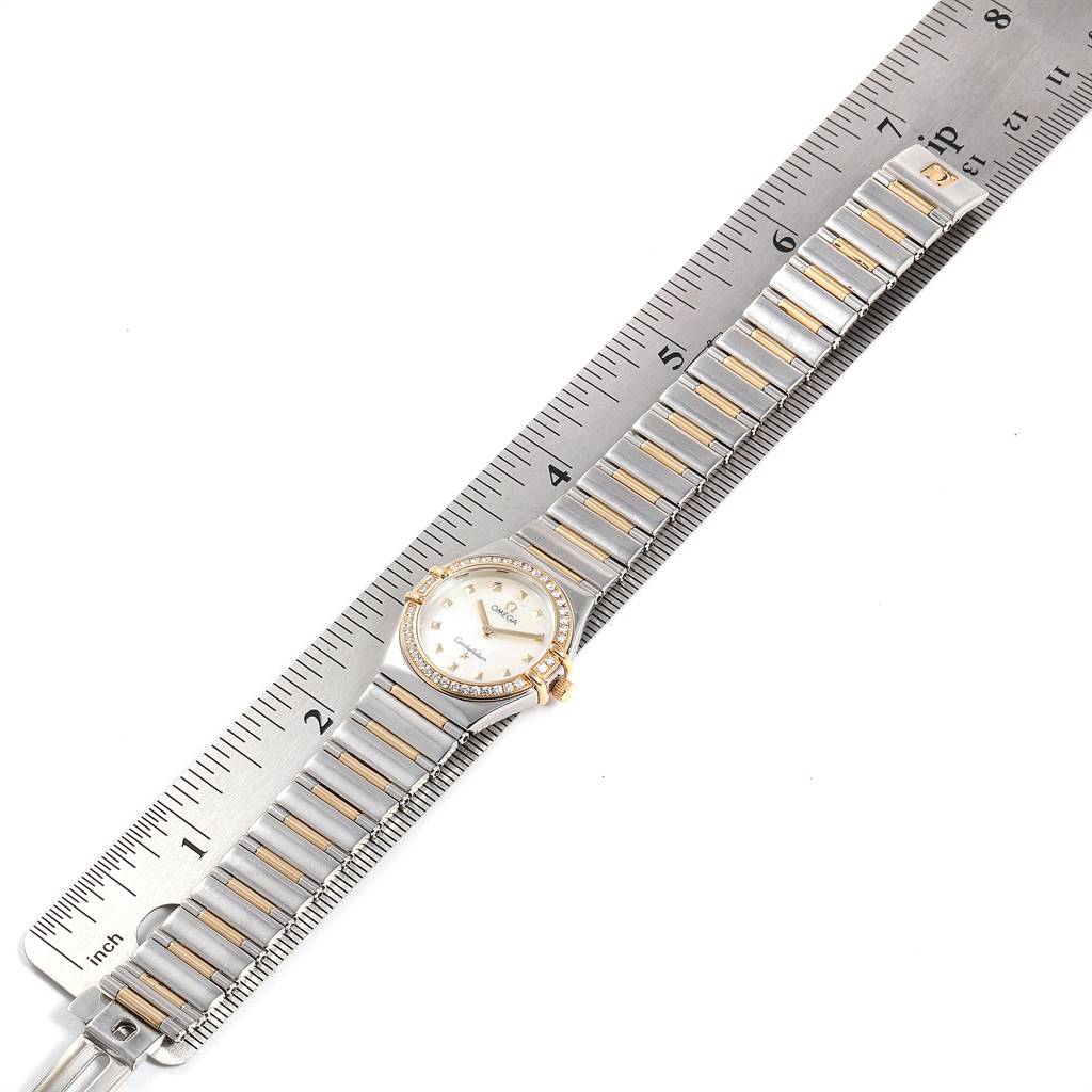 The image shows an Omega 1376.71.00 Women
s Steel and Gold (two tone) Mother of Pearl Dial 1376.71.00 Women
s Steel and Gold (two tone) Mother of Pearl Dial Constellation My Choice Steel Yellow Gold Diamond Watch 1376.71.00 laid flat next to a ruler for measurement.