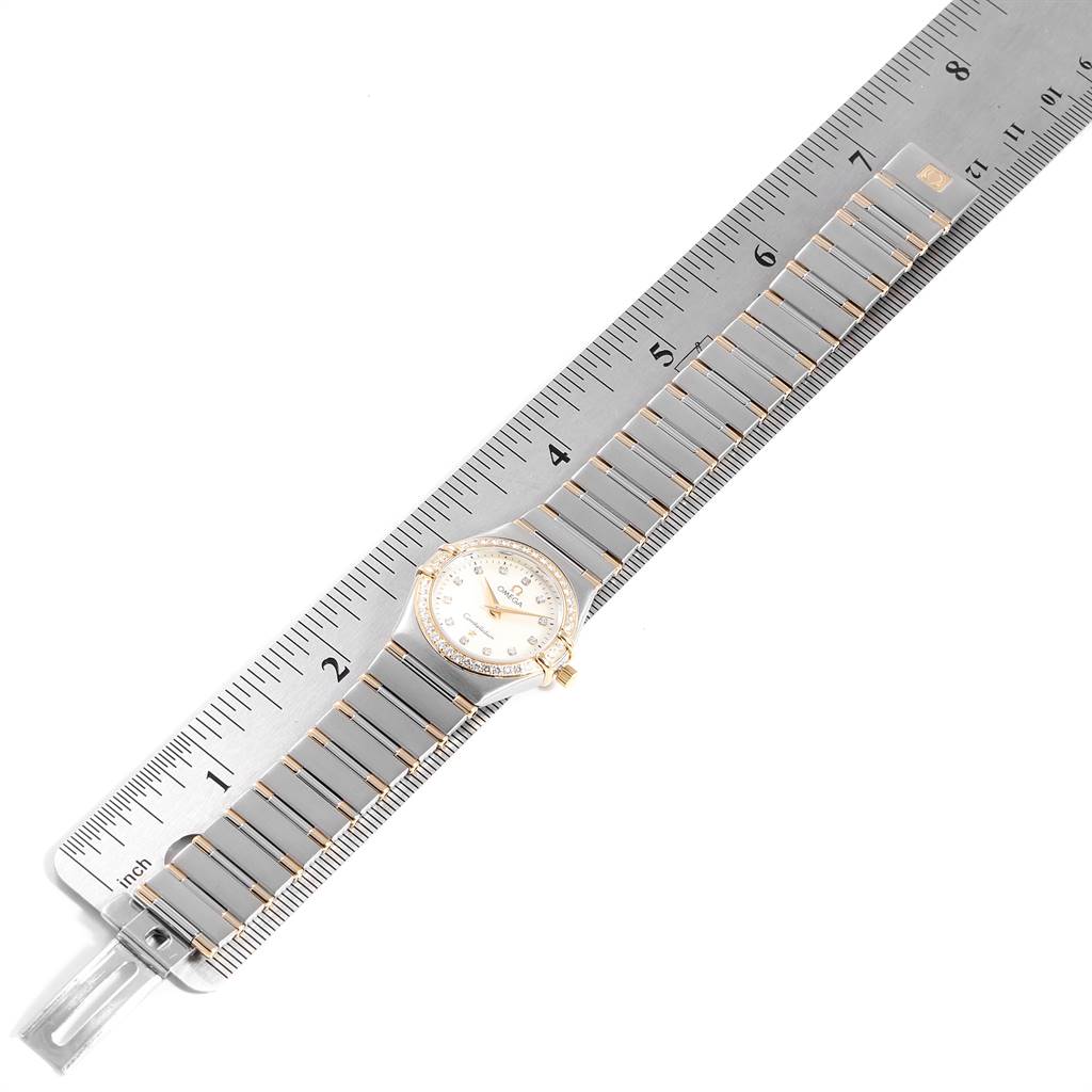 The Omega 1377.75.00 Women's Steel and Gold (two tone) Mother of Pearl Dial 1377.75.00 Women's Steel and Gold (two tone) Mother of Pearl Dial Constellation My Choice Steel Yellow Gold Diamond Watch 1377.75.00 is shown laid flat, with its band next to a ruler for scale.