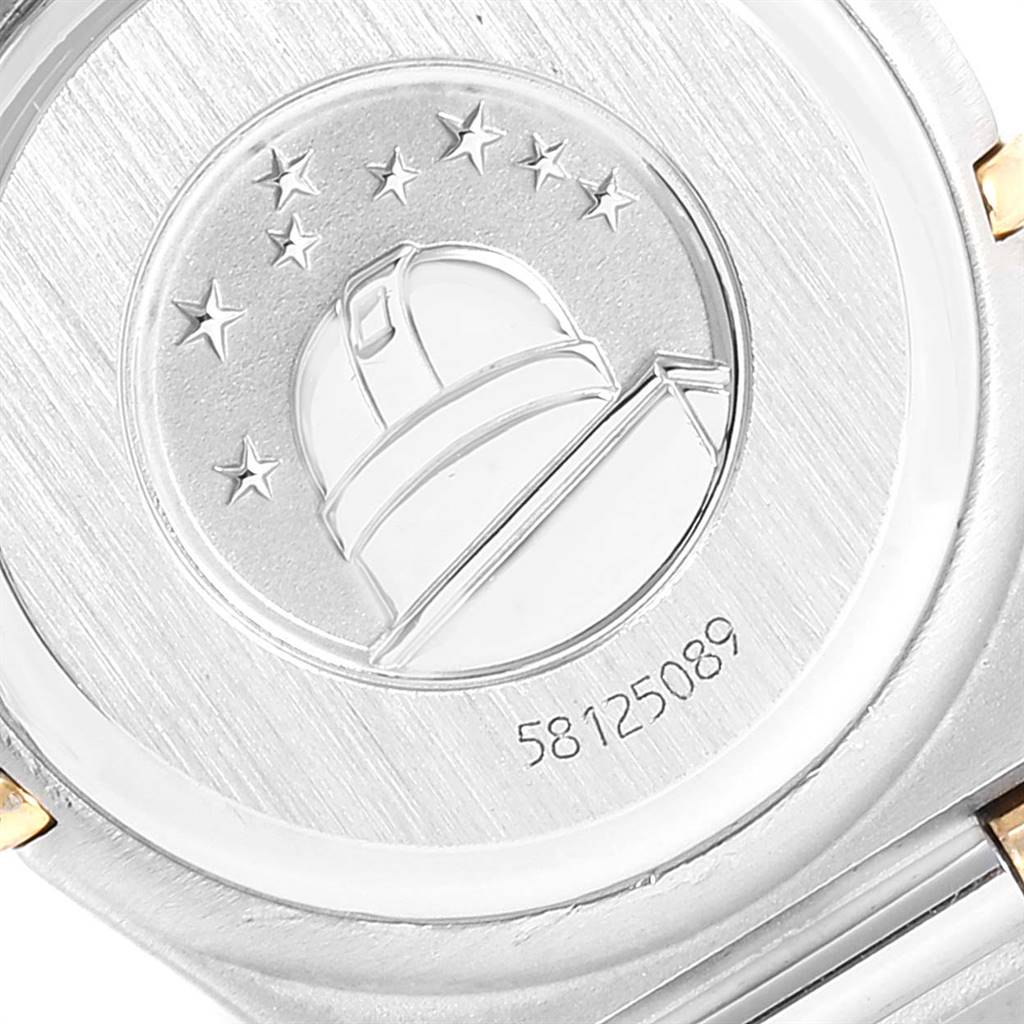 The image shows the back of the Omega 1372.70.00 Women's Steel and Gold (two tone) Mother of Pearl Dial 1372.70.00 Women's Steel and Gold (two tone) Mother of Pearl Dial Constellation Steel Yellow Gold Mother of Pearl Ladies Watch with an engraved observatory and stars.