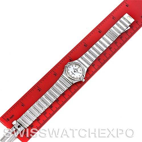 The image shows an overhead view of the Omega 1465.71.00 Women
s Stainless Steel Mother of Pearl Dial 1465.71.00 Women
s Stainless Steel Mother of Pearl Dial Constellation My Choice Ladies Quartz Mini Watch 1465.71.00 laid on a ruler.