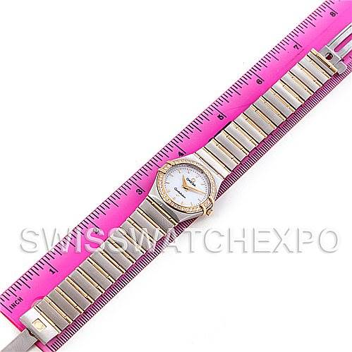 The image shows an Omega 1277.70.00 Women
s Steel and Gold (two tone) Mother of Pearl Dial 1277.70.00 Women
s Steel and Gold (two tone) Mother of Pearl Dial Constellation My Choice Steel Gold Diamond Watch 1277.70.00 model laid flat with a pink ruler for scale.