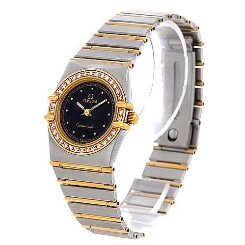 The image shows the Omega 1267.10.00 Women
s Steel and Gold (two tone) Black Dial 1267.10.00 Women
s Steel and Gold (two tone) Black Dial Constellation Diamond Mini 1267.10.00 watch at a three-quarter angle, highlighting its face and bracelet.
