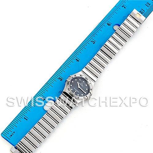 The image shows an Omega 1561.51.00 Women's Stainless Steel Grey Dial 1561.51.00 Women's Stainless Steel Grey Dial Constellation My Choice Quartz Mini Watch 15615100 model laid flat alongside a blue ruler.
