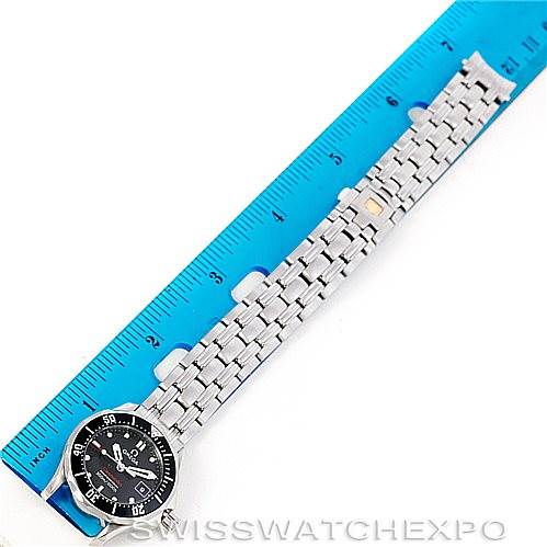 The image shows an Omega 212.30.28.61.01.001 Women's Stainless Steel Black Dial 212.30.28.61.01.001 Women's Stainless Steel Black Dial Seamaster Professional 300 M Ladies Watch 212.30.28.61.01.001 laid flat next to a blue ruler.