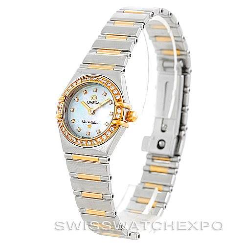The image shows an angled view of the Ladies Constellation Diamond Mini 1365.75.00 model watch by Omega 1365.75.00 Women
s Steel and Gold (two tone) Mother of Pearl Dial 1365.75.00 Women
s Steel and Gold (two tone) Mother of Pearl Dial, highlighting the watch face and band.
