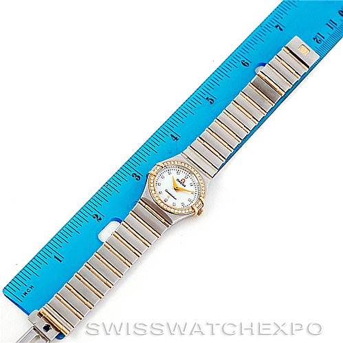 The Omega 123.25.24.60.55.003 Women
s Steel and Gold (two tone) Mother of Pearl Dial 123.25.24.60.55.003 Women
s Steel and Gold (two tone) Mother of Pearl Dial Constellation My Choice Steel Gold Diamond Watch 123.25.24.60.55.003 is shown fully extended next to a ruler.