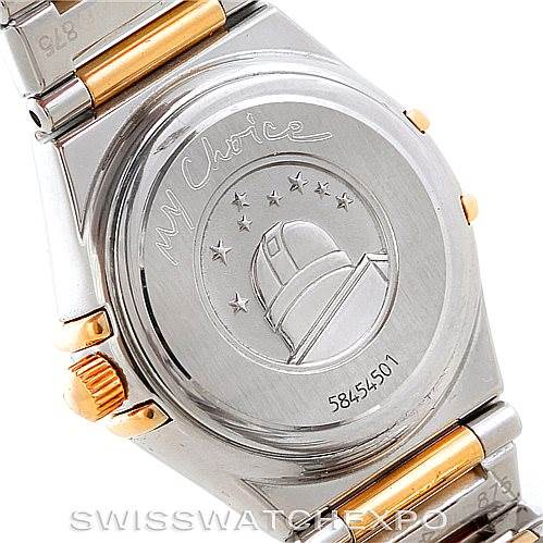 This image shows the case back of the Omega 1365.71.00 Women
s Steel and Gold (two tone) Mother of Pearl Dial 1365.71.00 Women
s Steel and Gold (two tone) Mother of Pearl Dial Ladies Constellation Diamond Mini 1365.71.00 watch, featuring engravings and part of the bracelet.