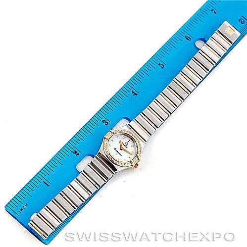 The image shows an aerial view of the Omega 1365.71.00 Women
s Steel and Gold (two tone) Mother of Pearl Dial 1365.71.00 Women
s Steel and Gold (two tone) Mother of Pearl Dial Constellation Diamond Mini 1365.71.00 watch alongside a blue ruler for scale.