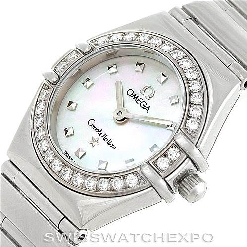 The image shows an Omega 1465.71.00 Women
s Stainless Steel Mother of Pearl Dial 1465.71.00 Women
s Stainless Steel Mother of Pearl Dial Constellation My Choice Ladies Mini Watch 1465.71.00 at an oblique angle, highlighting its diamond bezel and mother-of-pearl dial.