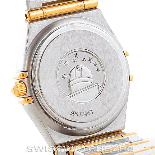 The image shows the back case and part of the metal strap of the Omega 1277.70.00 Women
s Steel and Gold (two tone) Mother of Pearl Dial 1277.70.00 Women
s Steel and Gold (two tone) Mother of Pearl Dial Constellation My Choice Steel Gold Diamond Watch 1277.70.00.