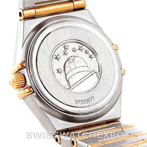 This image shows the back case of an Omega 1267.70.00 Women
s Steel and Gold (two tone) Mother of Pearl Dial 1267.70.00 Women
s Steel and Gold (two tone) Mother of Pearl Dial Constellation Ladies Diamond Mini Watch 1267.70.00, highlighting its engraved emblem and serial number.