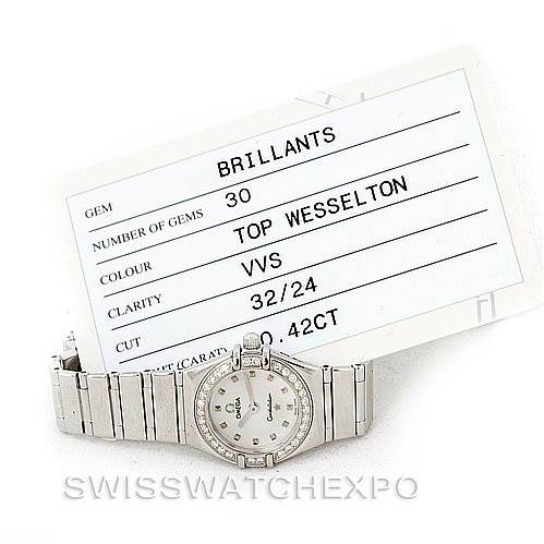 The image shows an Omega 1465.71.00 Women
s Stainless Steel Mother of Pearl Dial 1465.71.00 Women
s Stainless Steel Mother of Pearl Dial Constellation My Choice Ladies Mini Watch 1465.71.00, displayed laying flat with a certificate card behind it.