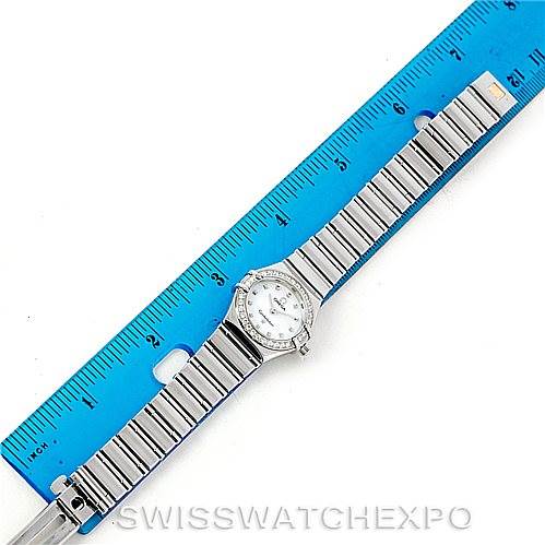 The image shows the Omega 1465.71.00 Women
s Stainless Steel Mother of Pearl Dial 1465.71.00 Women
s Stainless Steel Mother of Pearl Dial Constellation My Choice Ladies Mini Watch 1465.71.00 laid flat next to a ruler for scale.