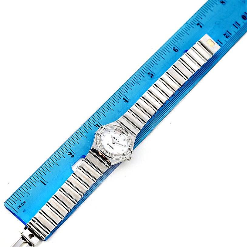 The Omega 1465.71.00 Women
s Stainless Steel Mother of Pearl Dial 1465.71.00 Women
s Stainless Steel Mother of Pearl Dial Constellation My Choice Ladies Diamond Mini Watch 1465.71.00 is shown flat with a blue ruler for scale.