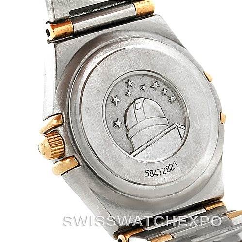 This image shows the back case of an Omega 1372.70.00 Women
s Steel and Gold (two tone) Mother of Pearl Dial 1372.70.00 Women
s Steel and Gold (two tone) Mother of Pearl Dial Constellation Steel and Gold Ladies Watch 1372.70.00, featuring the emblem and serial number.