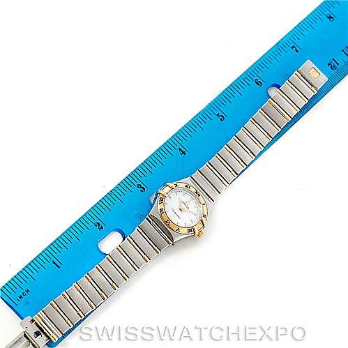 This image shows the Omega 1372.70.00 Women
s Steel and Gold (two tone) Mother of Pearl Dial 1372.70.00 Women
s Steel and Gold (two tone) Mother of Pearl Dial Constellation Steel and Gold Ladies Watch 1372.70.00 model laid flat next to a blue ruler.