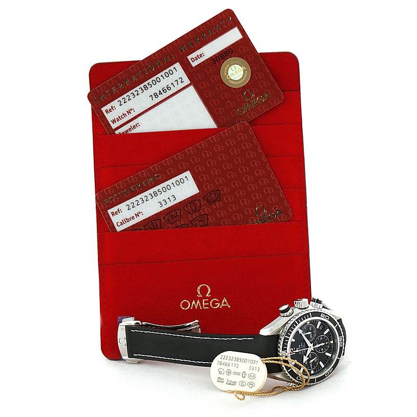 This image shows the Omega 222.32.38.50.01.001 Women's Stainless Steel Black Dial 222.32.38.50.01.001 Women's Stainless Steel Black Dial Seamaster Planet Ocean Ladies Watch 222.32.38.50.01.001 with warranty cards and a red Omega 222.32.38.50.01.001 Women's Stainless Steel Black Dial 222.32.38.50.01.001 Women's Stainless Steel Black Dial cardholder.