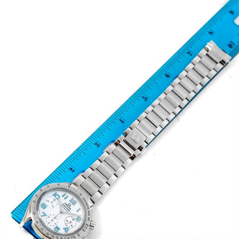 The image shows an Omega 3534.71.00 Women's Stainless Steel Mother of Pearl Dial 3534.71.00 Women's Stainless Steel Mother of Pearl Dial Speedmaster Ladies Mother of Pearl Dial Watch 3534.71.00 laid flat next to a blue ruler.