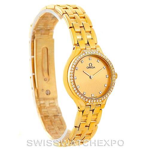 The image shows an Omega Women's Yellow Gold Champagne Dial Women's Yellow Gold Champagne Dial DeVille Ladies 18K Yellow Gold Diamond Watch from an angled side view, highlighting the face, bezel, and bracelet.
