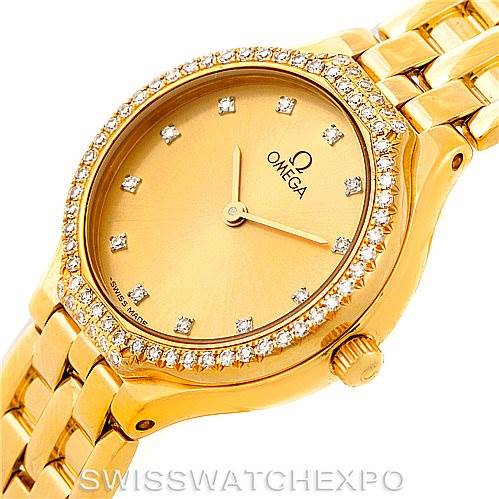 This image shows an angled view of the Omega Women's Yellow Gold Champagne Dial Women's Yellow Gold Champagne Dial DeVille Ladies 18K Yellow Gold Diamond Watch, highlighting its dial, bezel, and part of the bracelet.