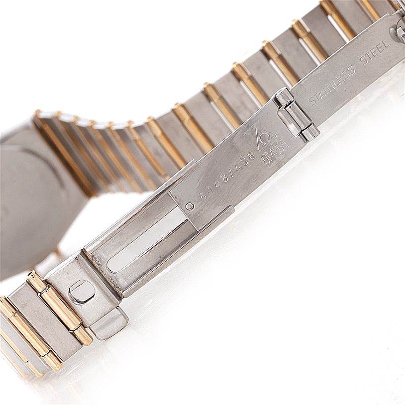 The image shows the clasp and part of the bracelet of the Omega Women
s Steel and Gold (two tone) Champagne Dial Women
s Steel and Gold (two tone) Champagne Dial Constellation Mini Steel 18K Yellow Gold Diamond Watch.