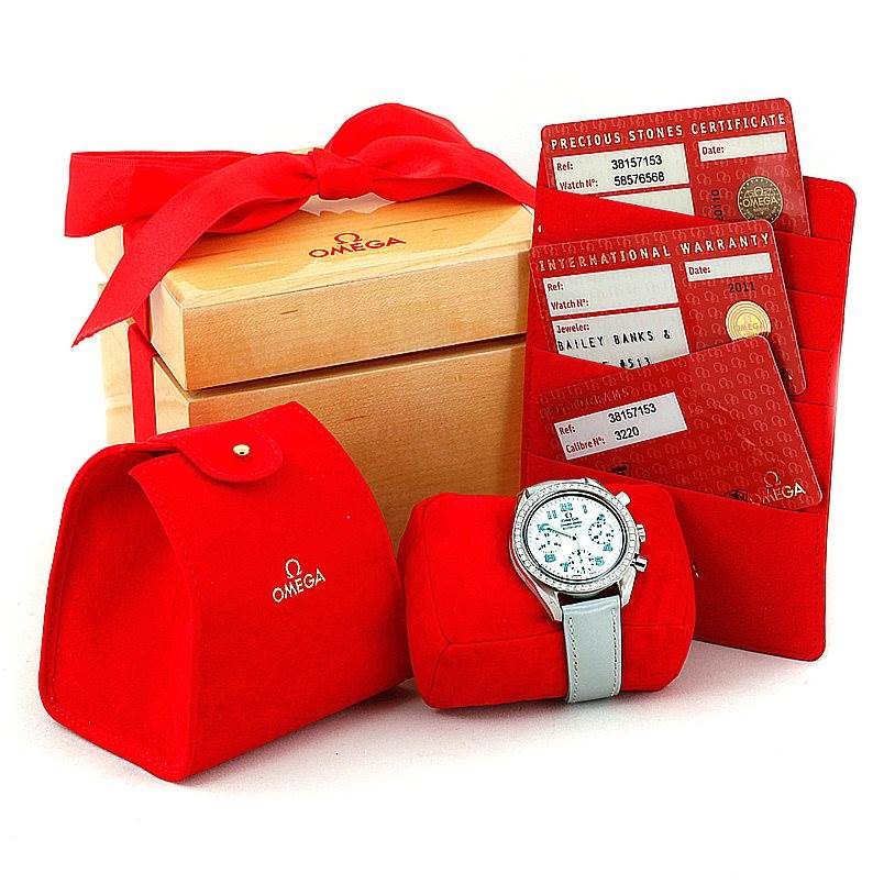 The image shows an Omega 3815.71.53 Women
s Stainless Steel Mother of Pearl Dial 3815.71.53 Women
s Stainless Steel Mother of Pearl Dial Speedmaster Ladies Diamond MOP Dial Watch 3815.71.53 with its accessories, including red packaging and certificates.